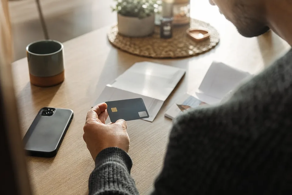 Payment card on a desk next to a phone