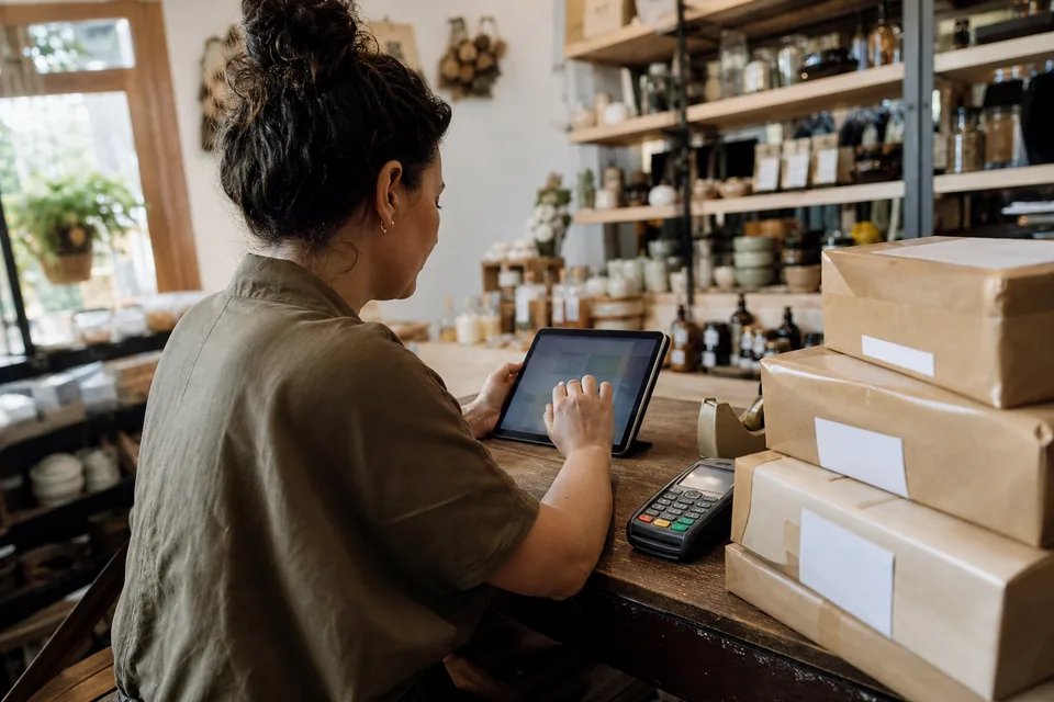 Store owner with tablet at the counter