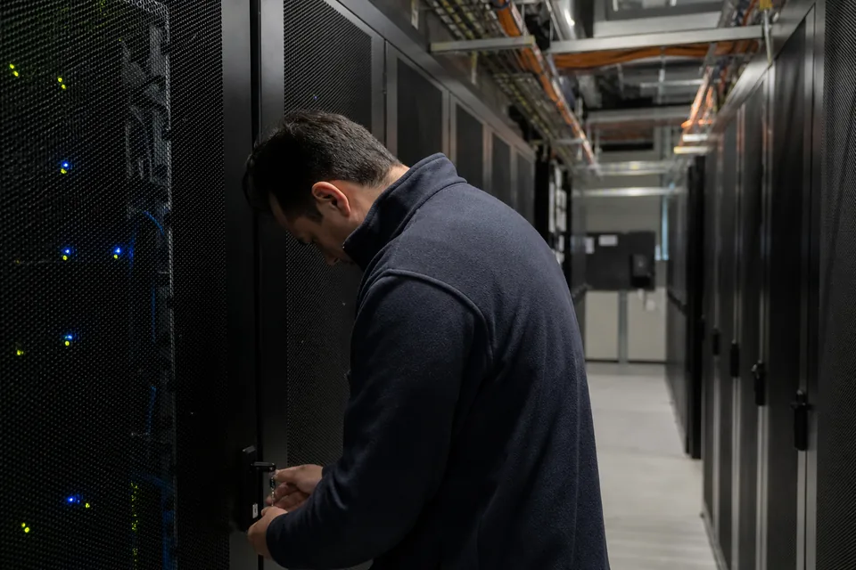 Server room aisle with locked racks